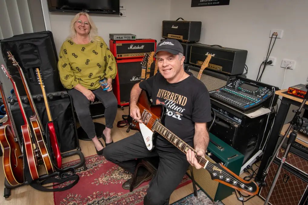 David Dobson with guitars and amps, wearing a Riverbend Blues shirt